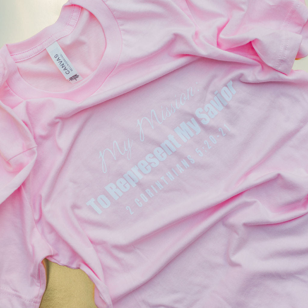 a flat lay of a pink christian t-shirt