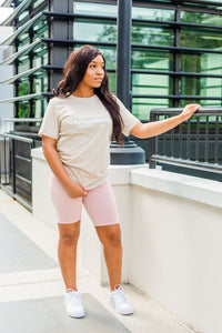 woman in a tan christian t shirt